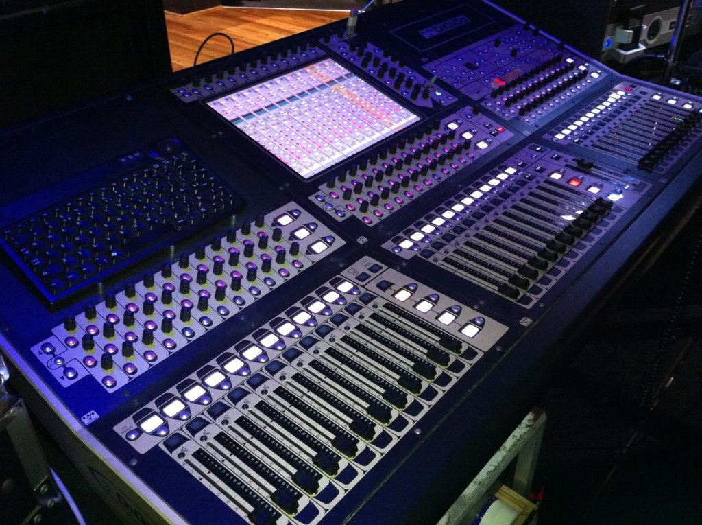 Digital mixing console with faders, meters, and a touch screen
