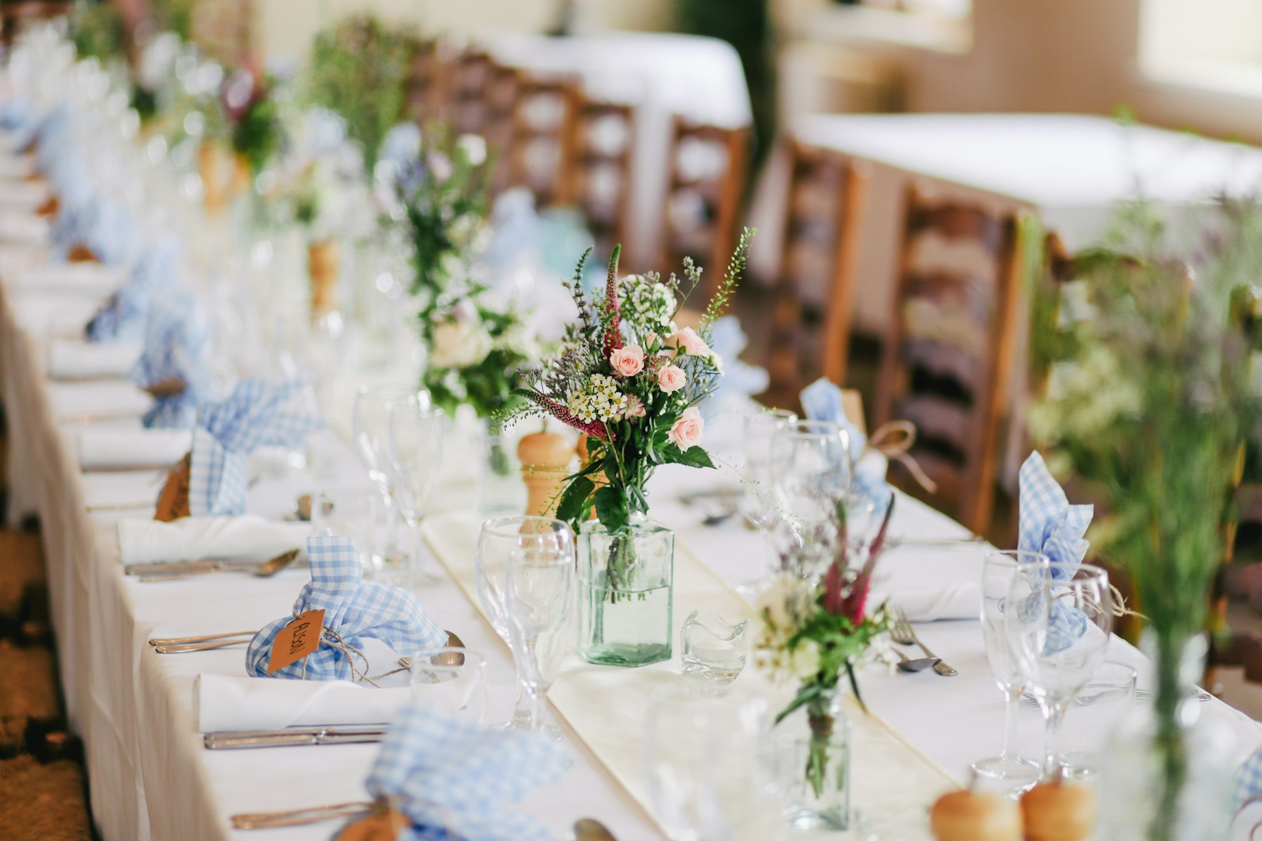 Decorated wedding reception table under warm event lighting